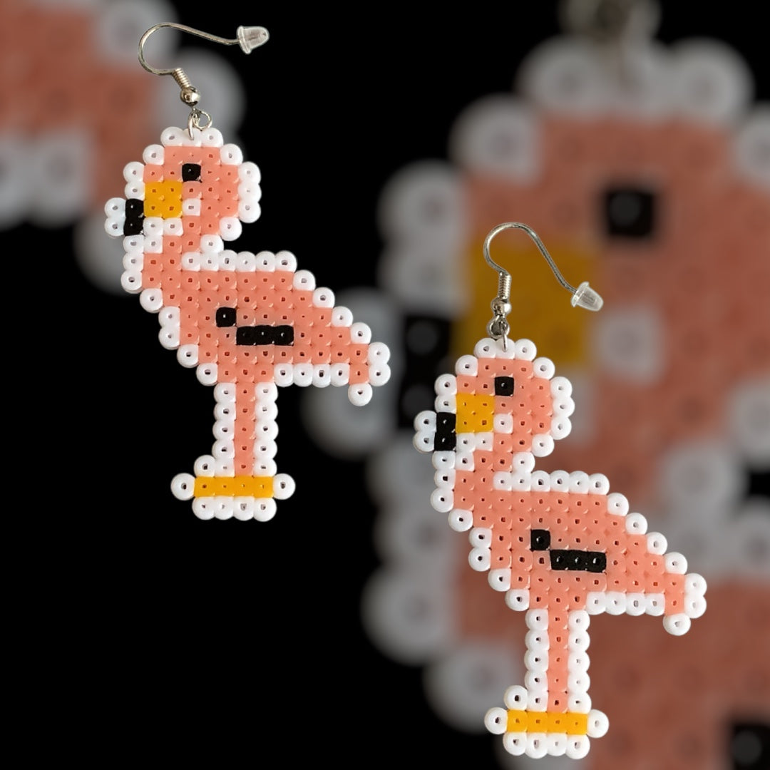 Handmade fuse bead earrings featuring stylised flamingo design with nickel-free hook findings on kraft card backing