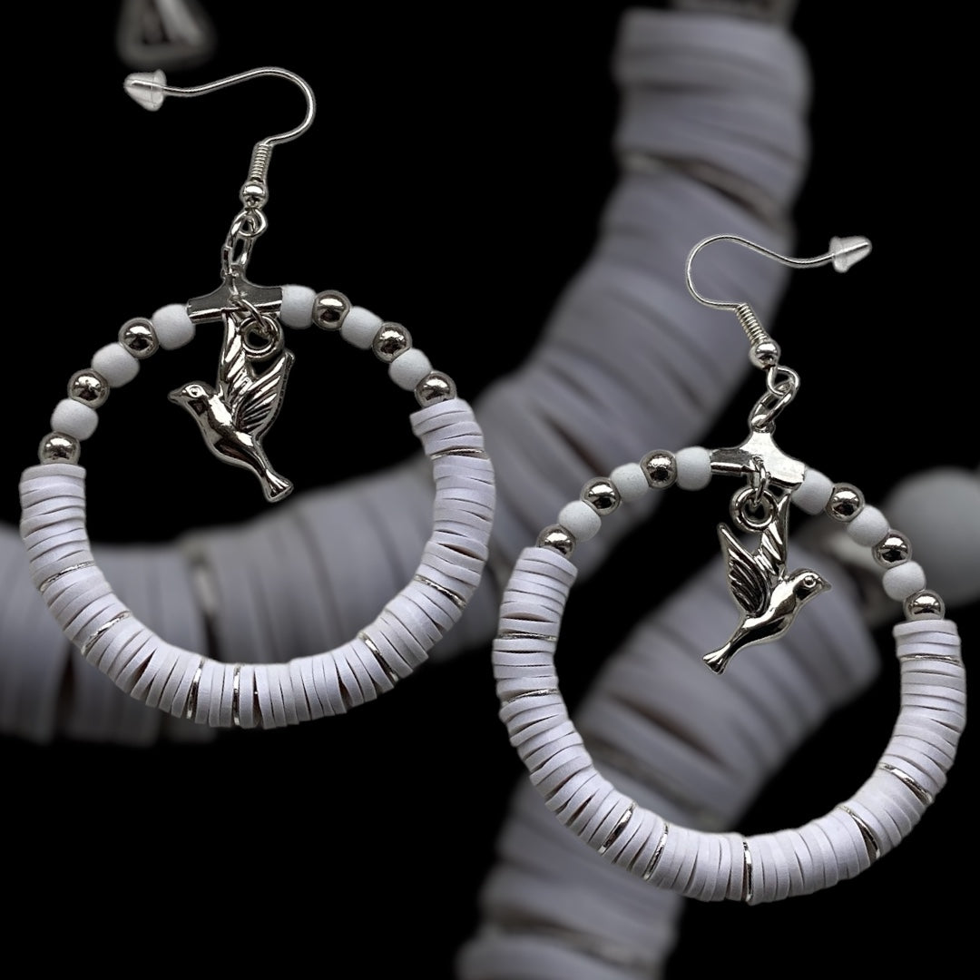 Silver Tone:
White handmade hoop earrings with silver-tone beads and a dangling bird charm, crafted from polymer clay with silver accent slices, minimalist lightweight jewellery on black background